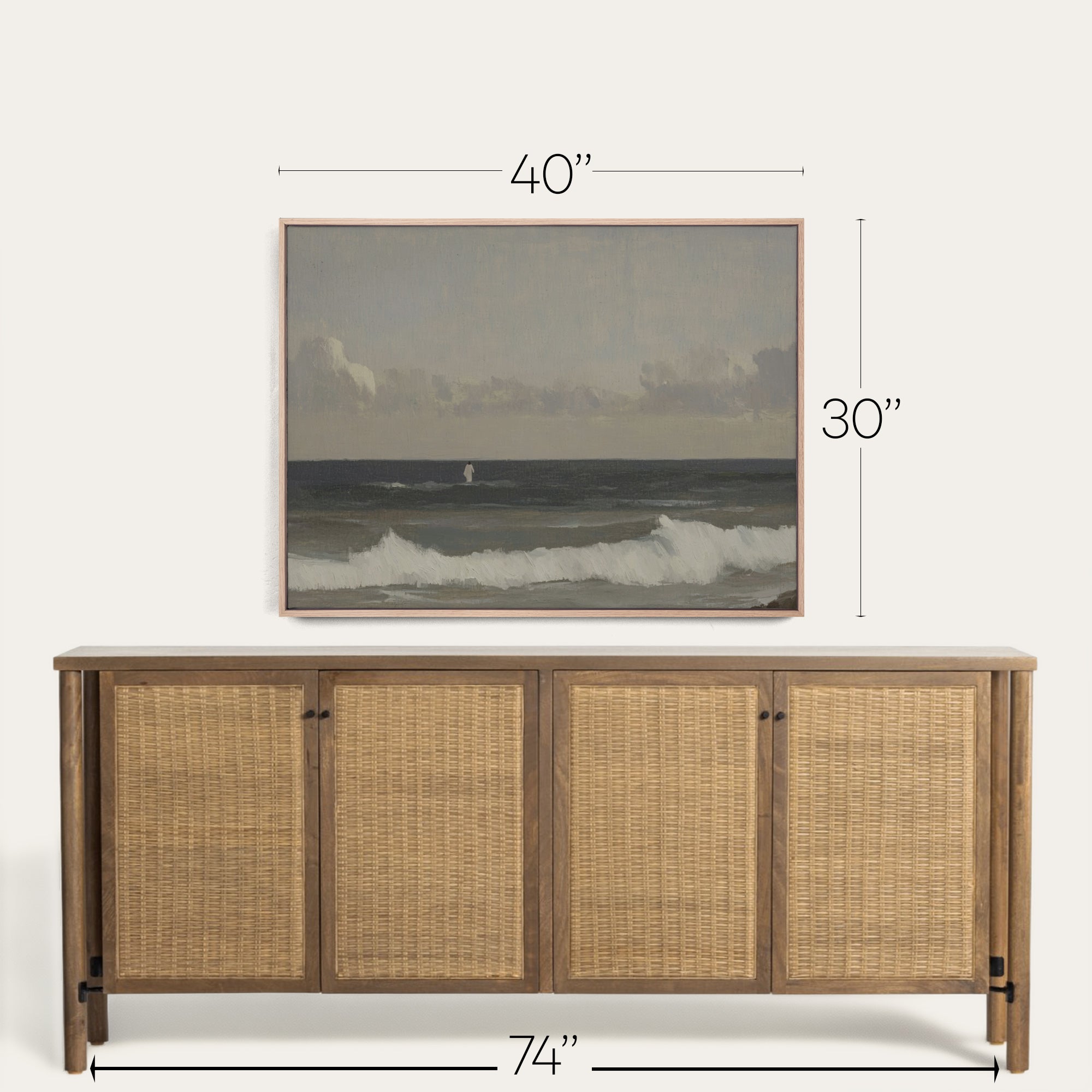Wooden sideboard with wicker doors and framed artwork above on a white background 