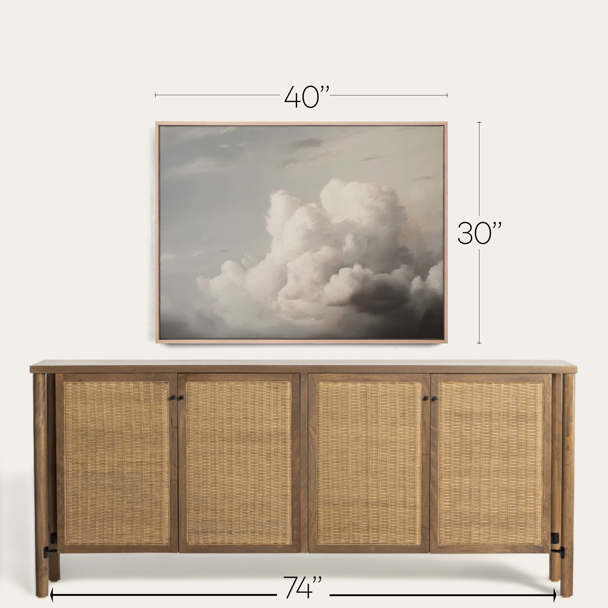 Wooden sideboard with wicker doors and framed artwork above it on a white background 