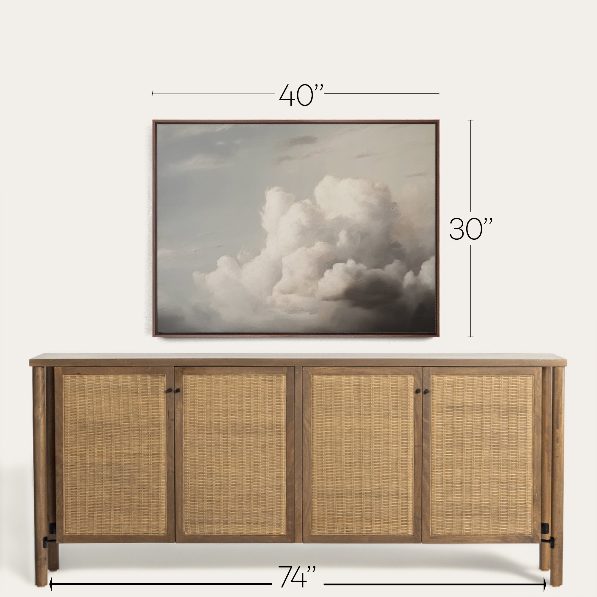 Wooden sideboard with wicker doors and a framed cloud art piece above it on a white background. 