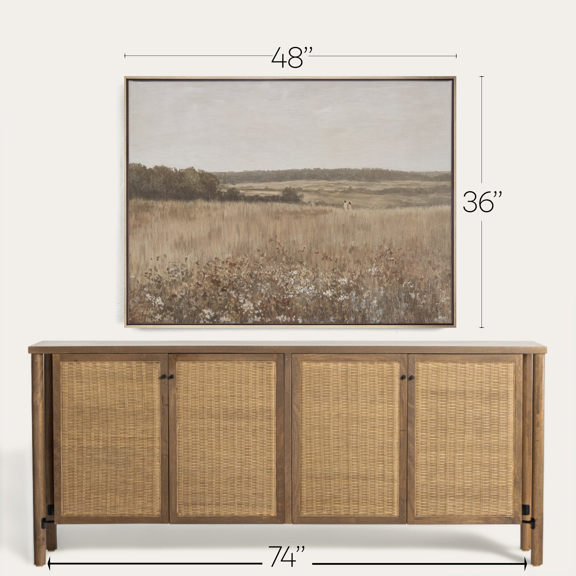 Wicker sideboard with framed landscape art above it on a white background 