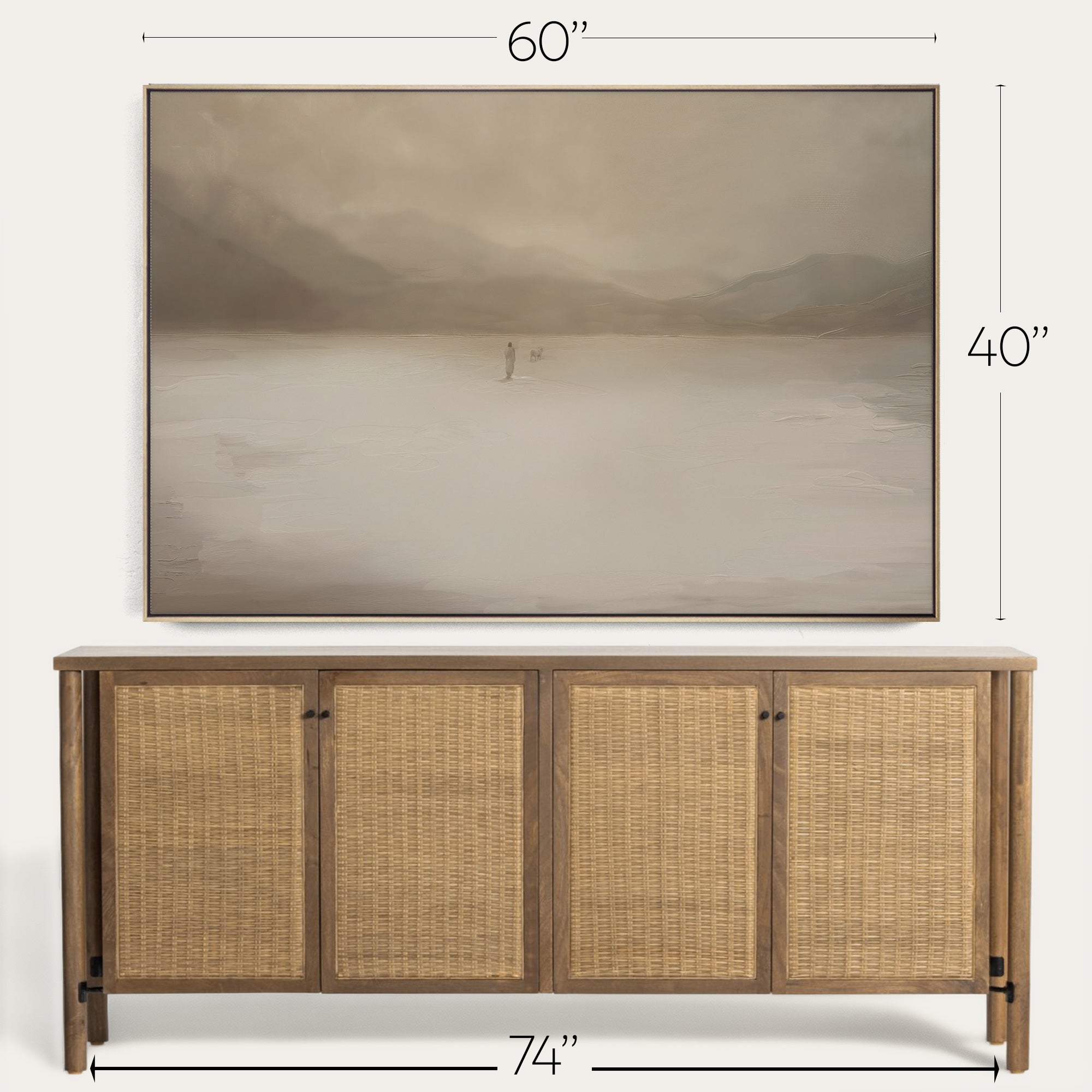 Wooden sideboard with wicker doors and a painting above it on a white wall. 