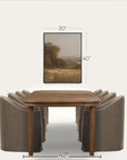 wooden dining table with four gray chairs and a framed landscape painting on a white background. 