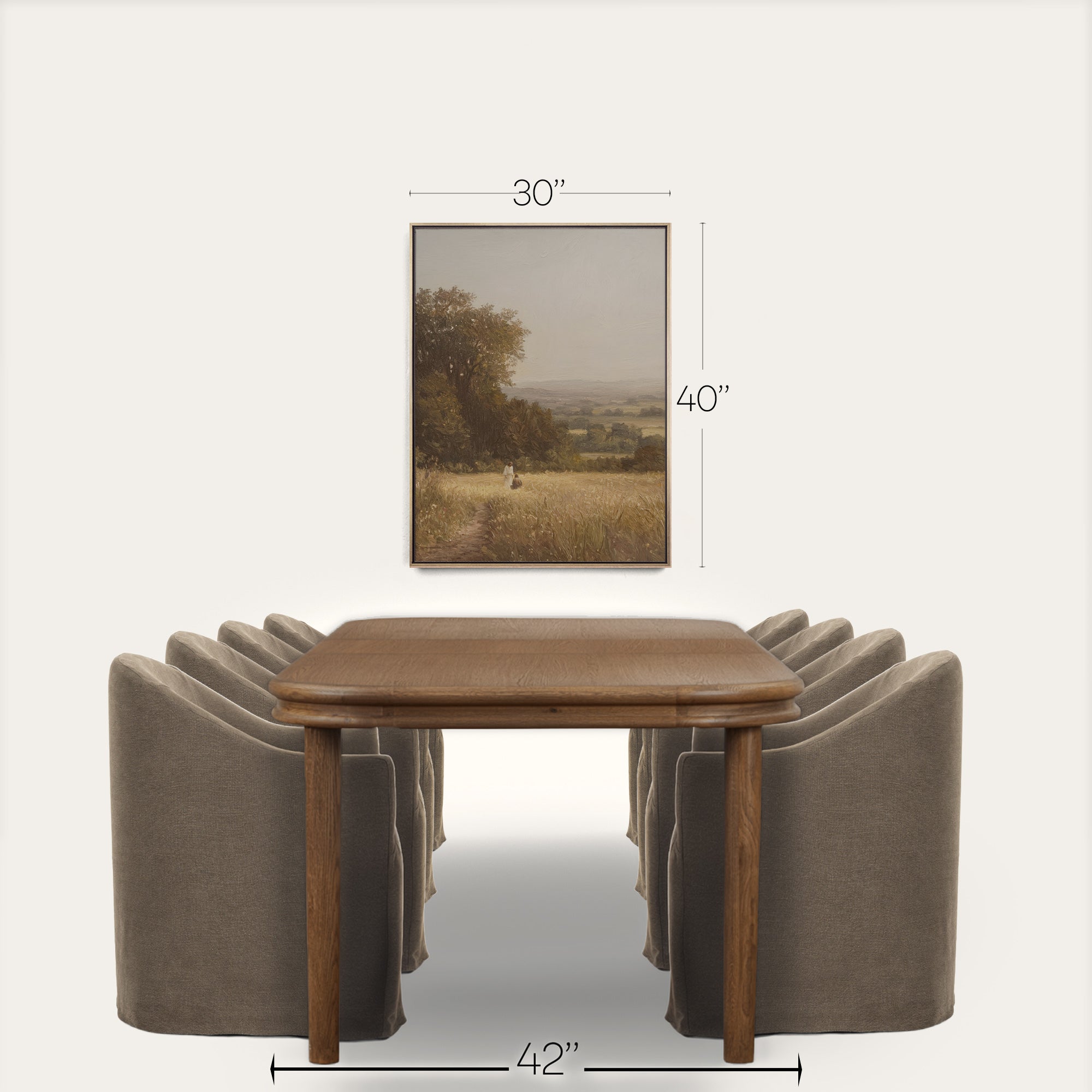 Wooden dining table with four gray chairs and a framed landscape painting on a white background. 