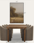 framed landscape painting above a wooden table with gray chairs, showing dimensions. 
