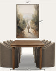 dining room setup with a wooden table and gray chairs, featuring a landscape painting above. 