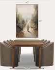 dining room setup with a wooden table and gray chairs, featuring a wall art piece. 