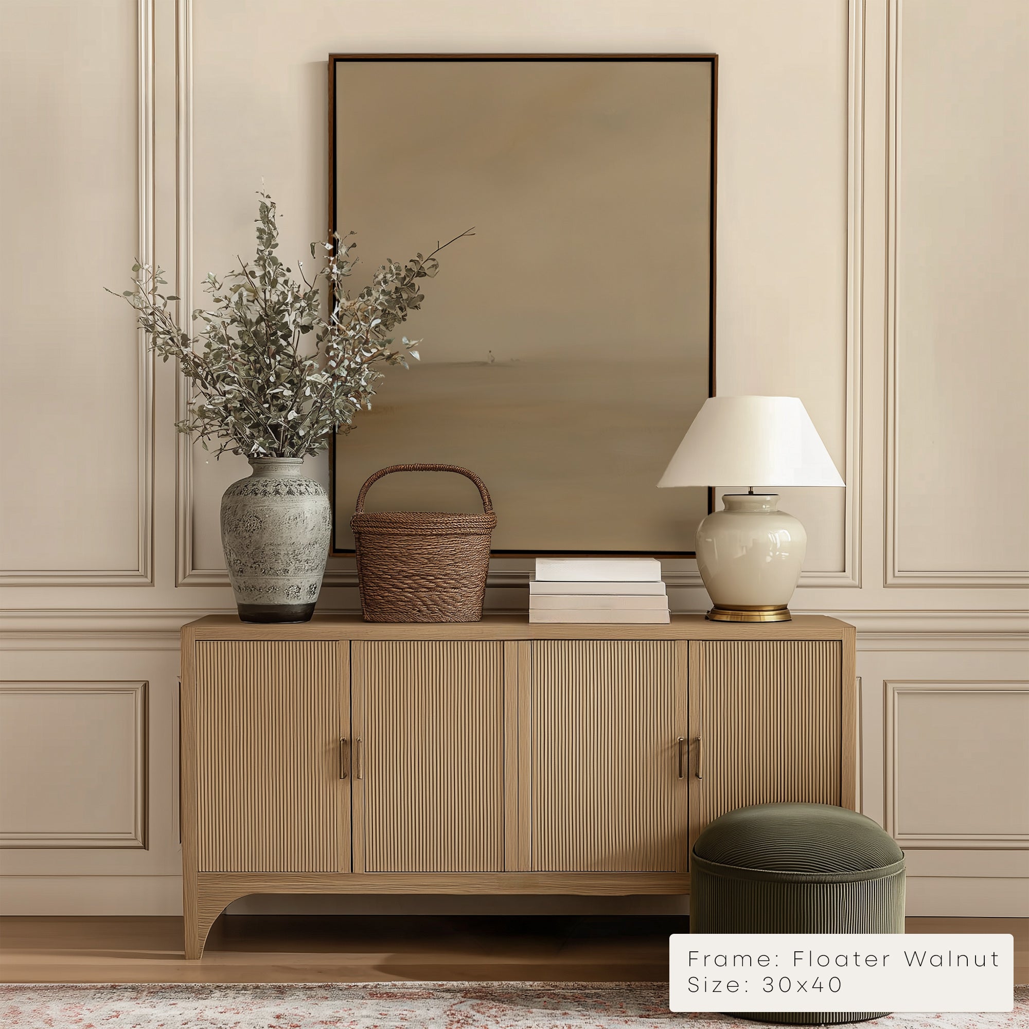 Wooden sideboard with decorative items against a beige wall with a framed artwork.