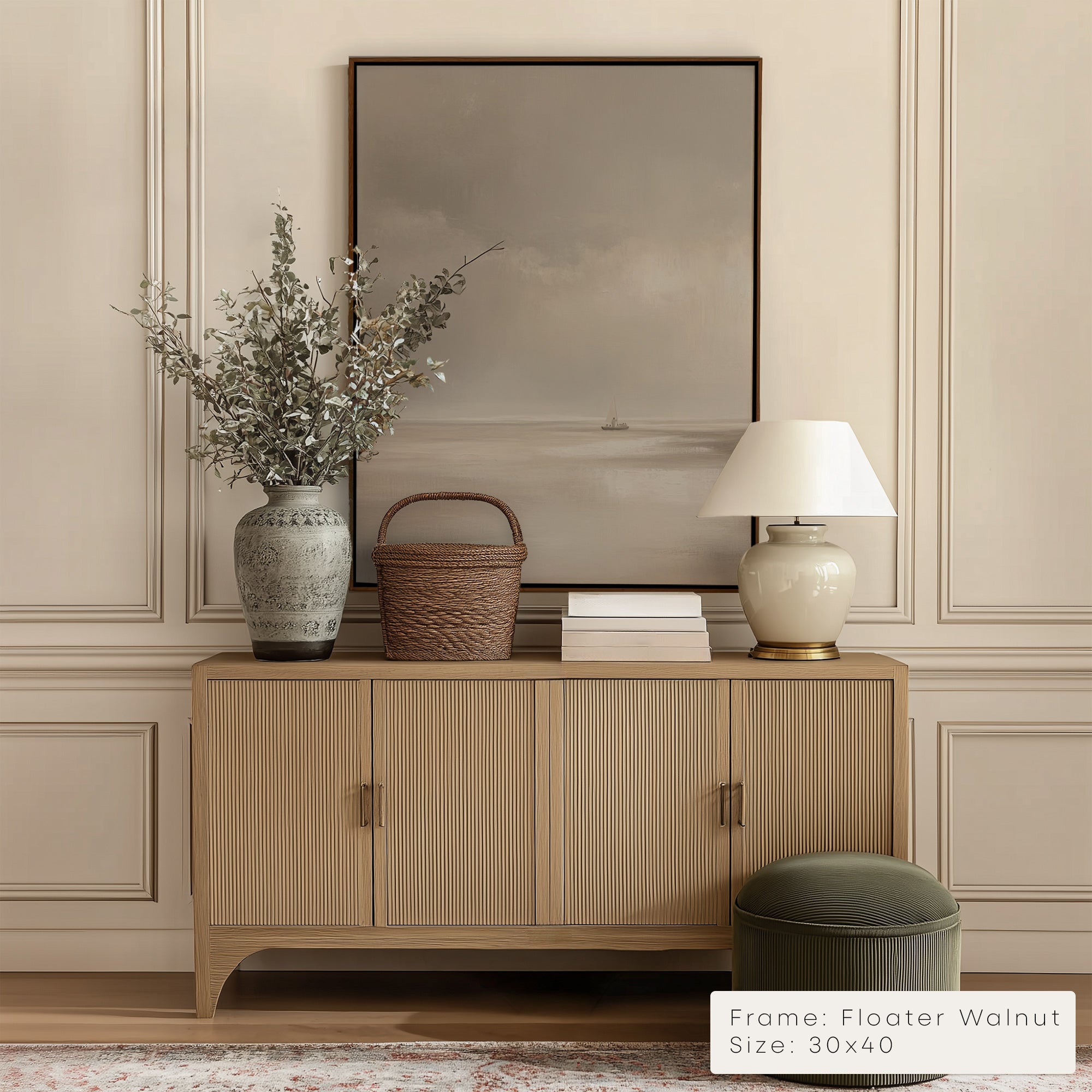 Wooden sideboard with decorative items against a beige wall with a framed picture.