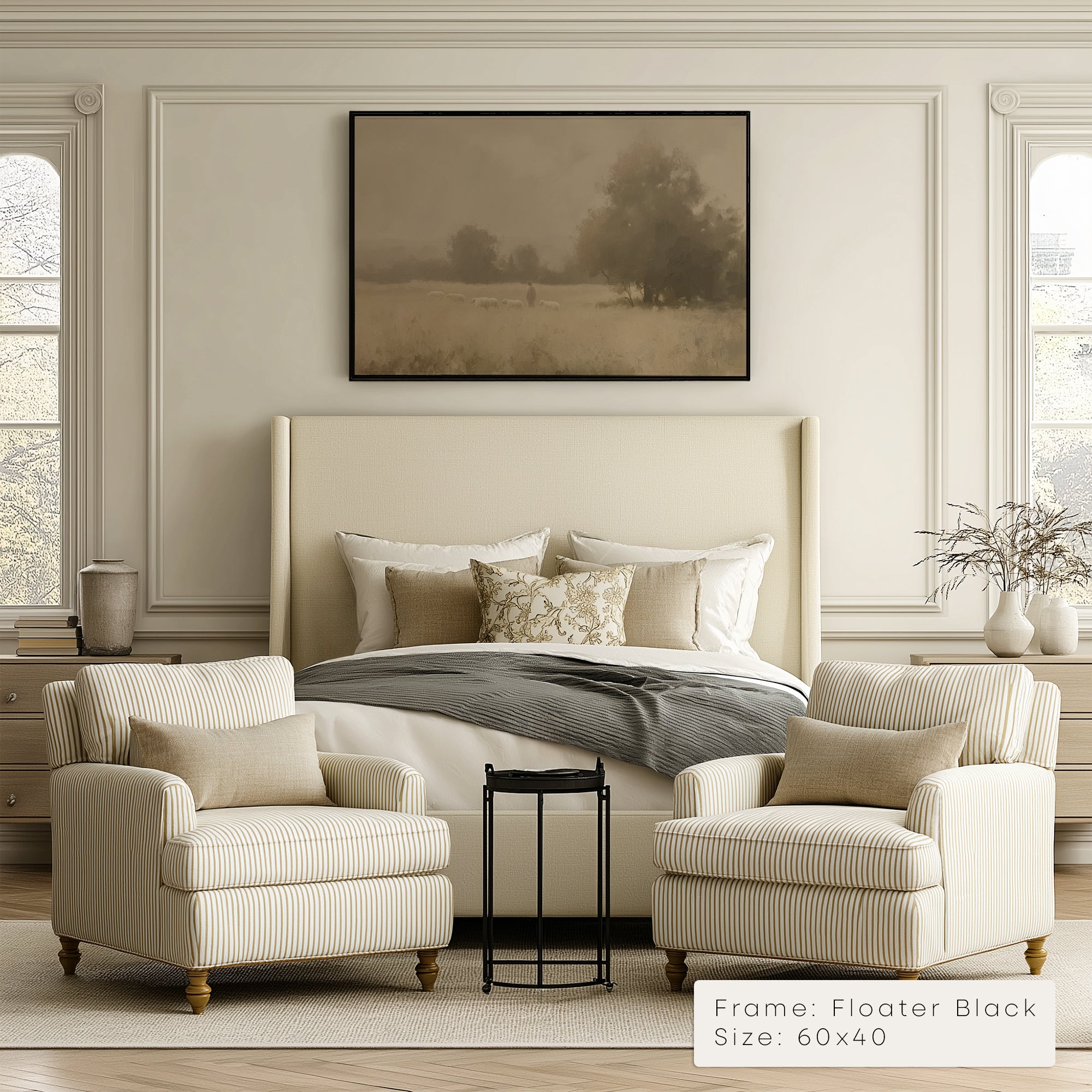 Neatly decorated bedroom with a bed, armchairs, and framed artwork.