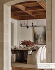 dining room with wooden ceiling and a framed artwork on the wall.