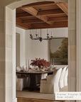 dining room with a table set for dinner, framed artwork on the wall, and a chandelier. __lifestyleimage