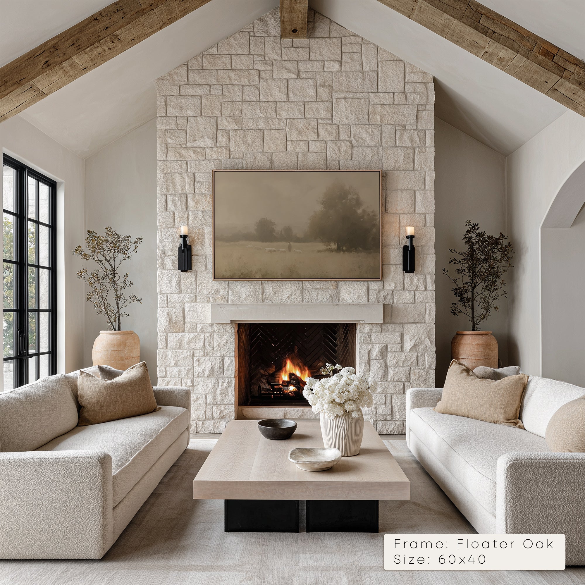 Living room with stone fireplace, white sofas, and a TV above the fireplace.