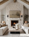 living room with stone fireplace, white sofas, and a tv above the fireplace.