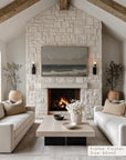 living room with stone fireplace, white sofas, and a tv above the fireplace.