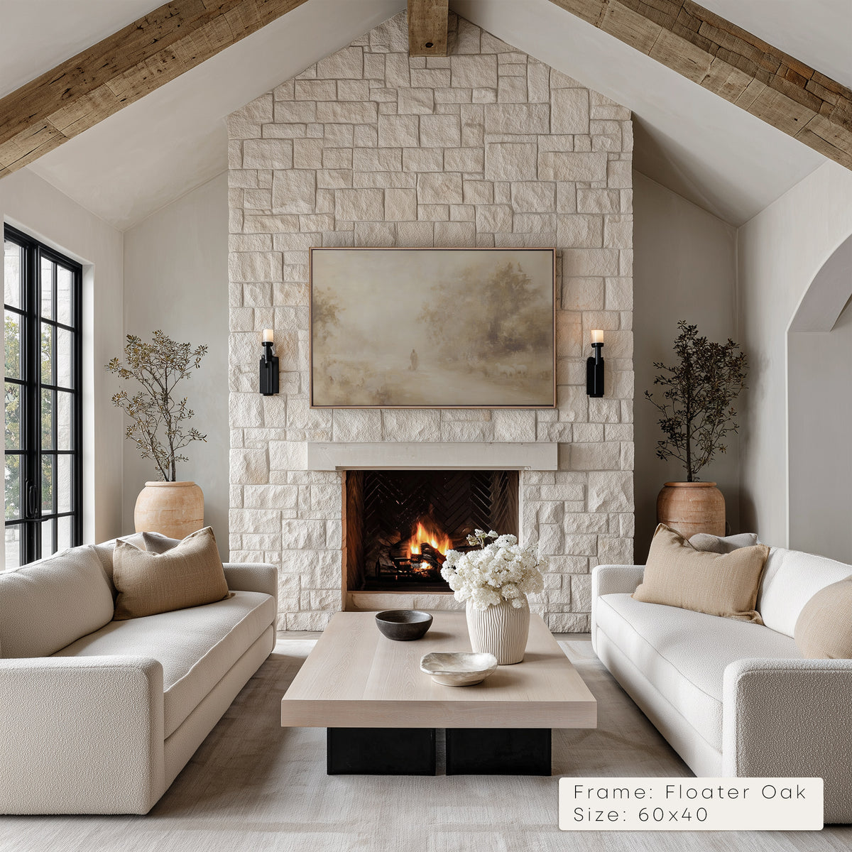 Living room with stone fireplace, white sofas, and decorative elements.