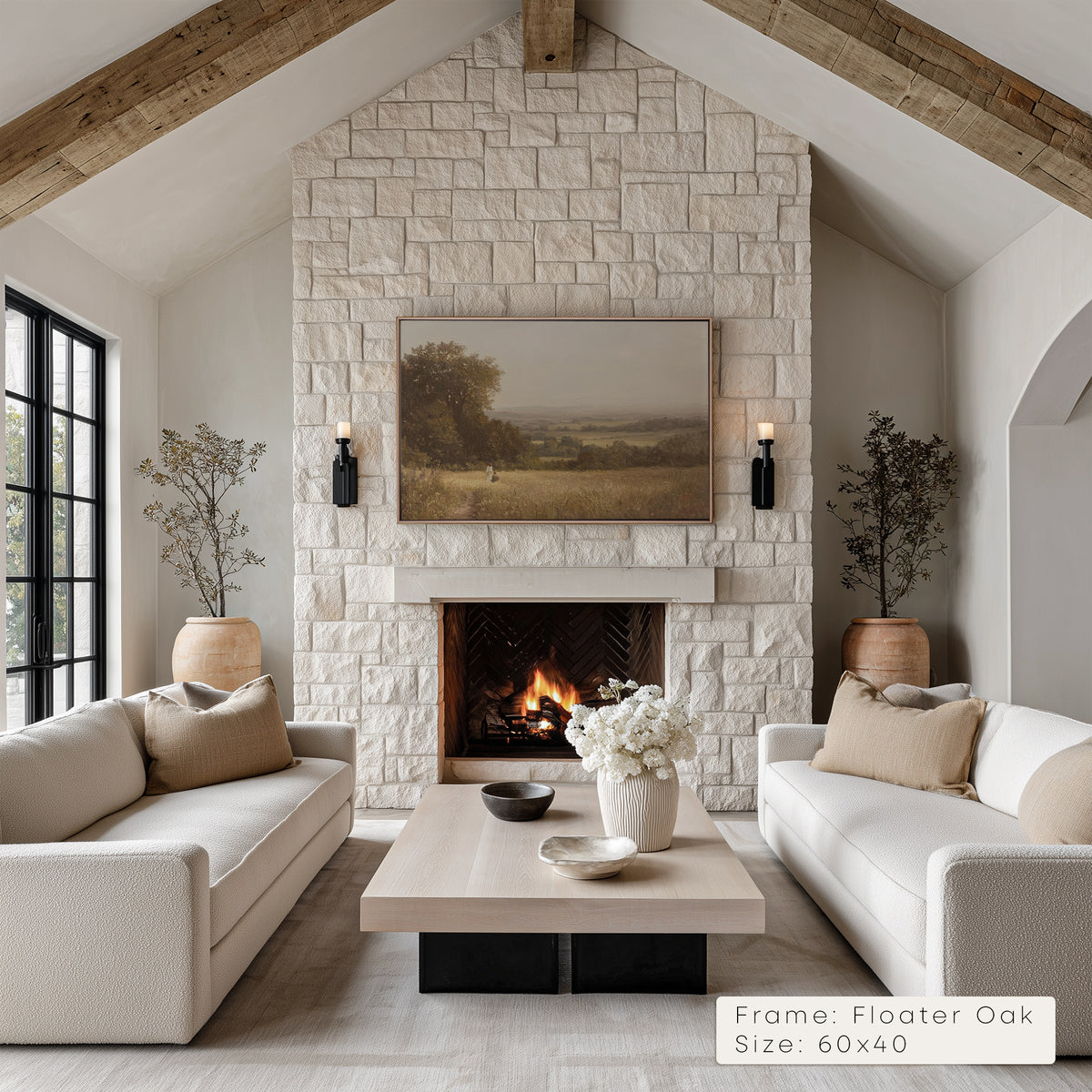 Living room with stone fireplace, white sofas, and a painting above the fire. __lifestyleImage