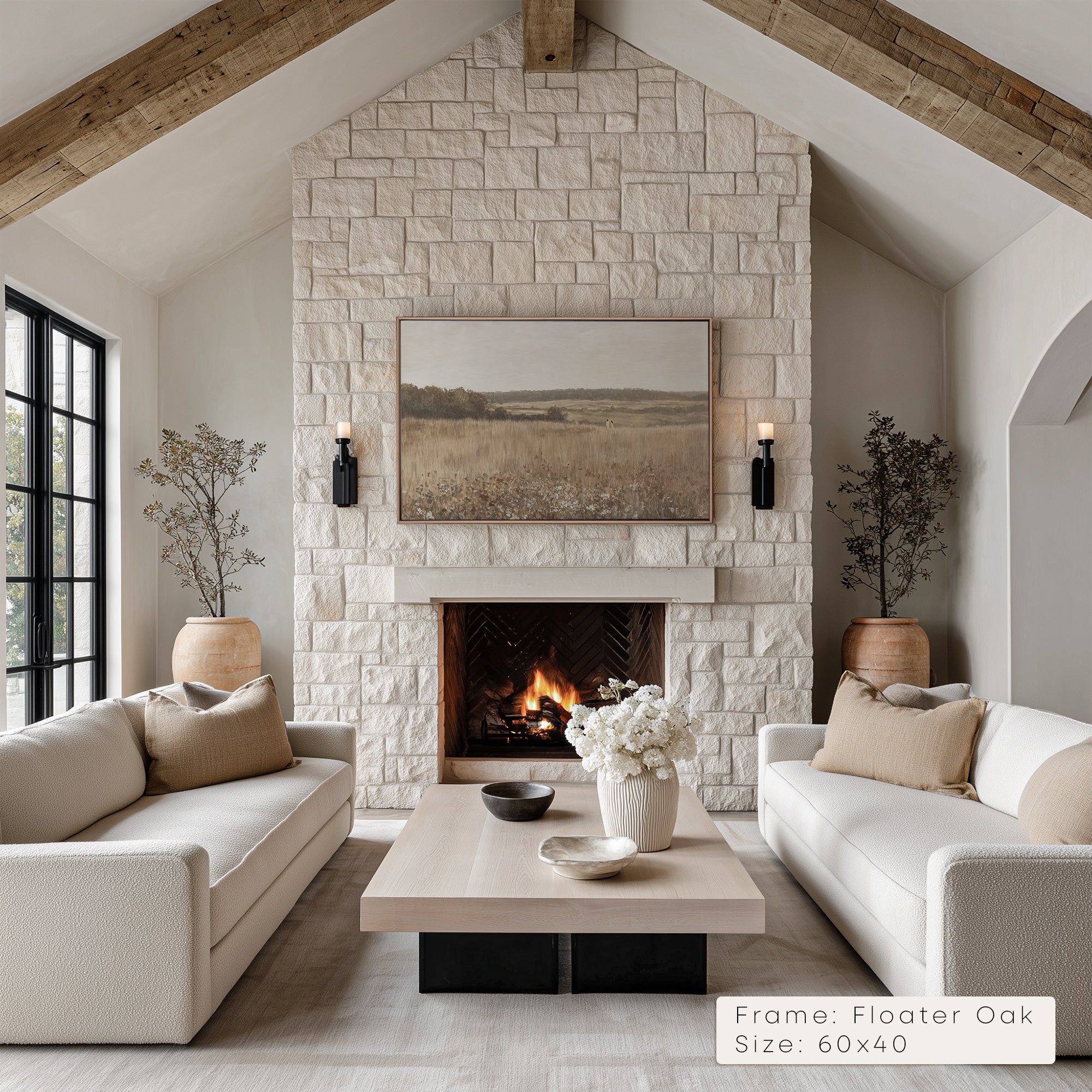 Living room with stone fireplace, white sofas, and a coffee table.