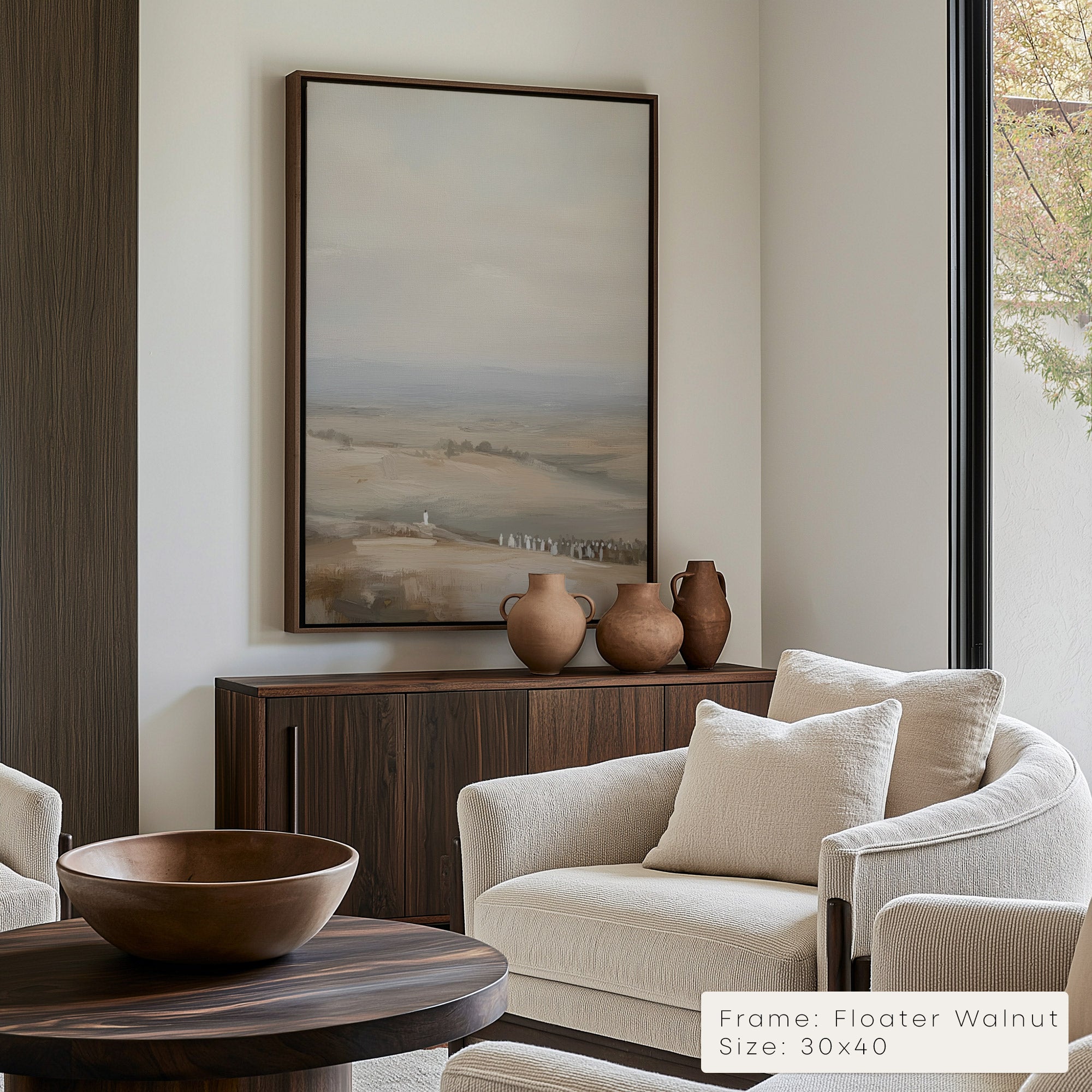Modern living room with a neutral color scheme, featuring a large landscape painting above a wooden console table.