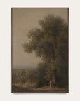 a framed landscape painting featuring a large tree with a small group of figures near its base, set against a muted beige sky and distant hills, shown hanging on a light wall. 