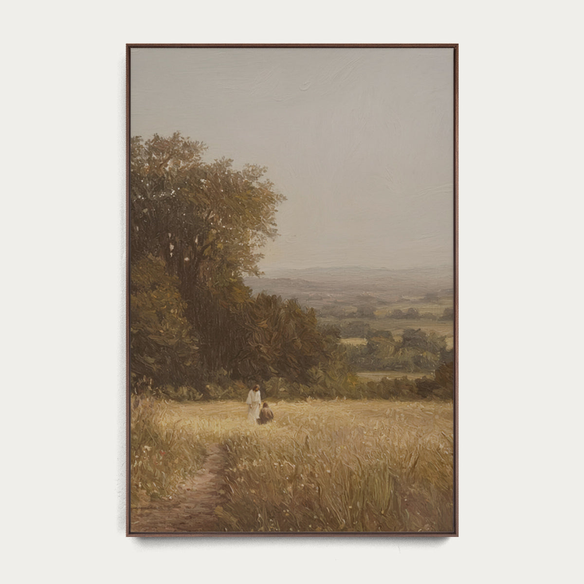 Framed painting of a landscape with a person walking on a path in a field. 